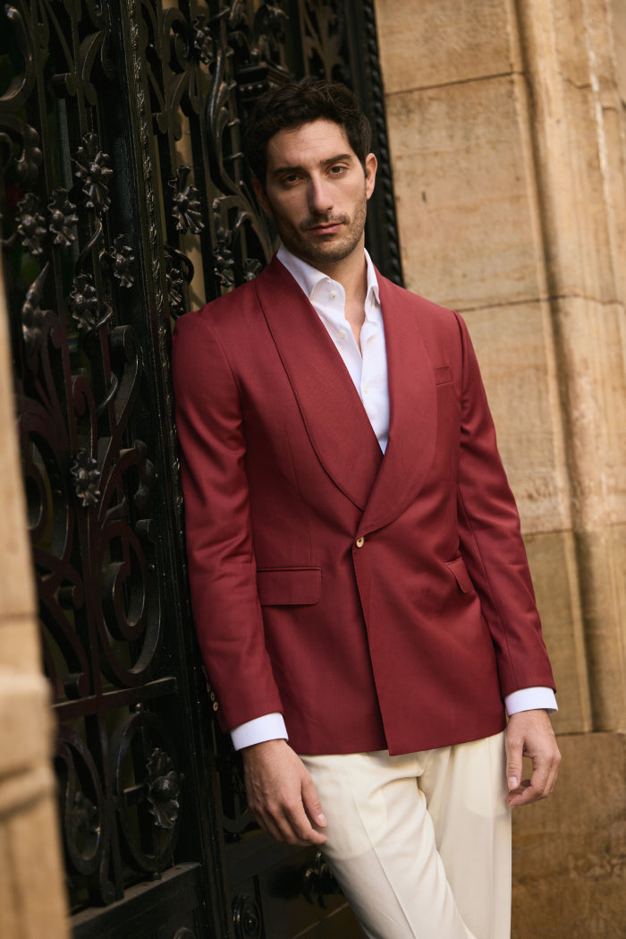 Man wearing red blazer with white shirt and cream trousers smart casual outfit