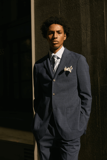 men’s blue suit with tie and pocket square formal tailored outfit styling