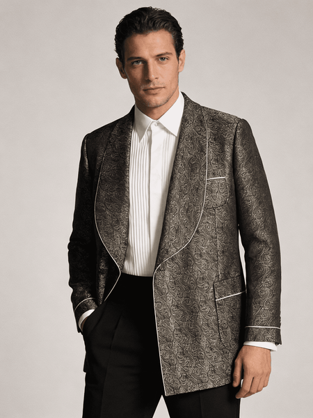 Man wearing a patterned blazer over a white shirt with a plain background