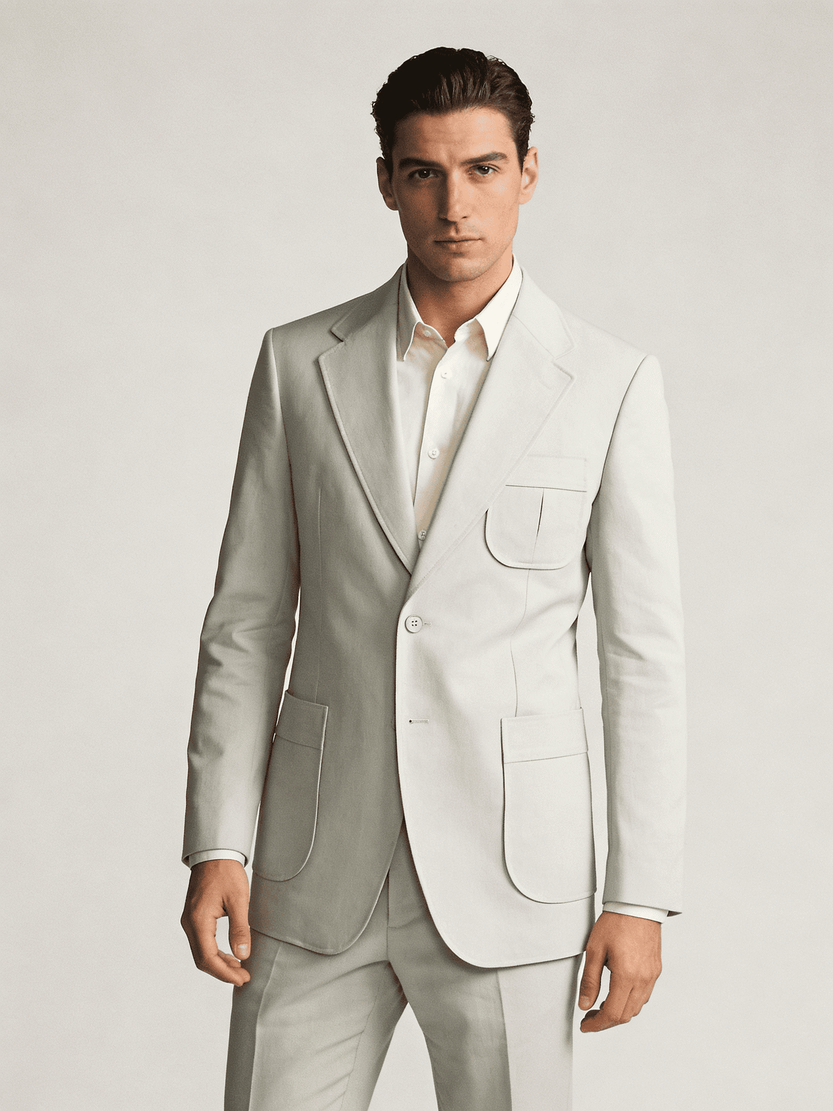 Man wearing a light gray suit on a plain background