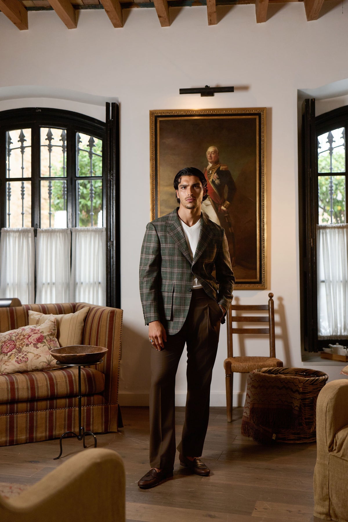 Man wearing green plaid blazer with brown trousers elegant smart casual outfit indoors