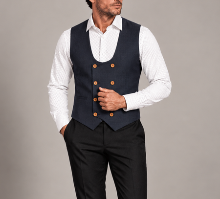 Man wearing a navy double-breasted waistcoat with contrasting brown buttons, a white patterned dress shirt, and black trousers.