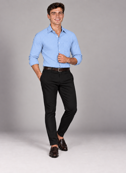 Man wearing a men's signature light blue jacquard dress shirt with black trousers and brown loafers.