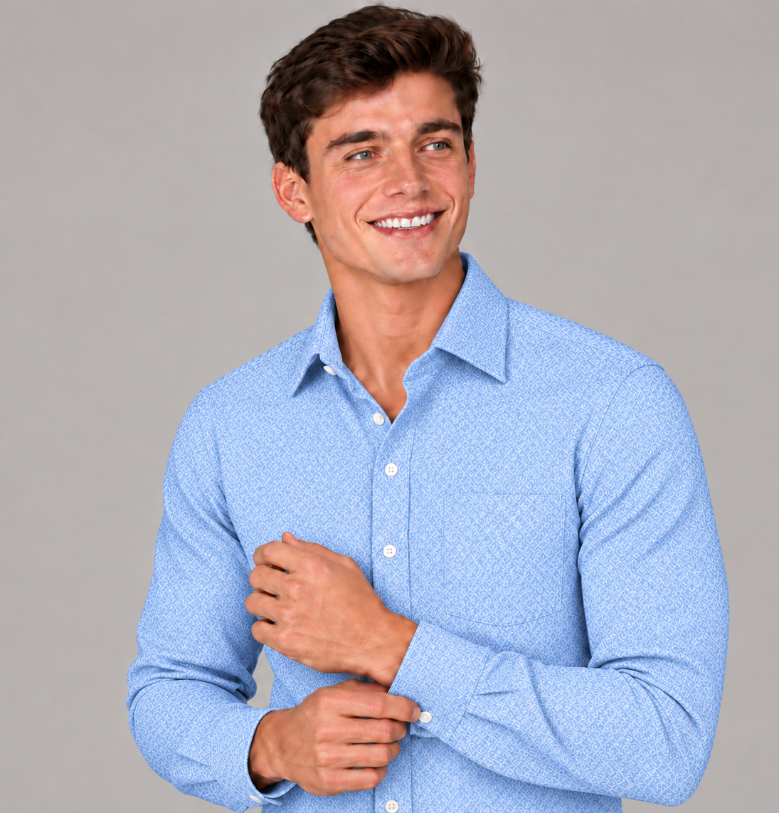 Close-up of a men's signature light blue jacquard dress shirt featuring a subtle geometric pattern and button cuffs.