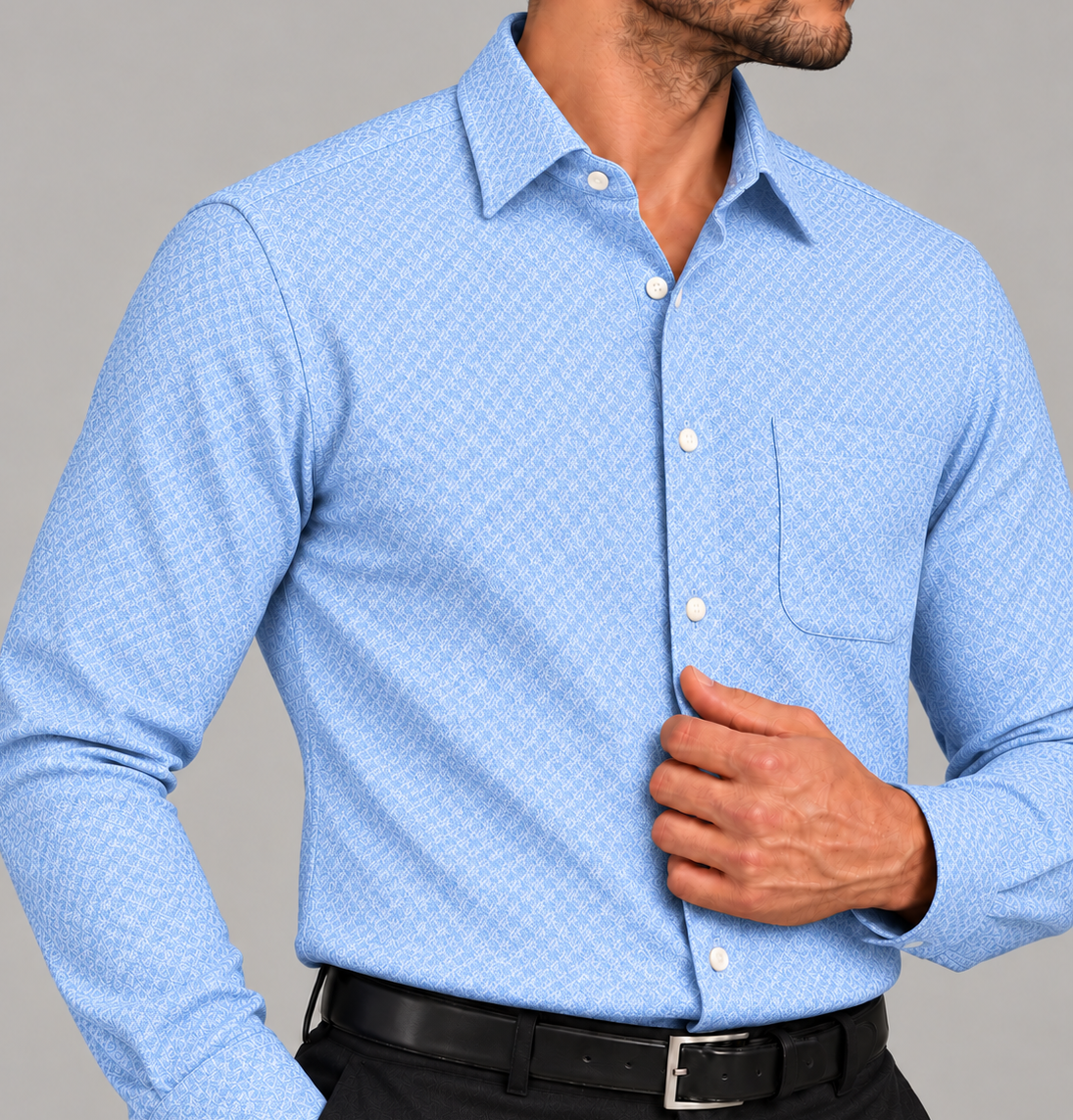 Close-up of a men's signature light blue jacquard dress shirt with a subtle geometric pattern, classic collar, and chest pocket.