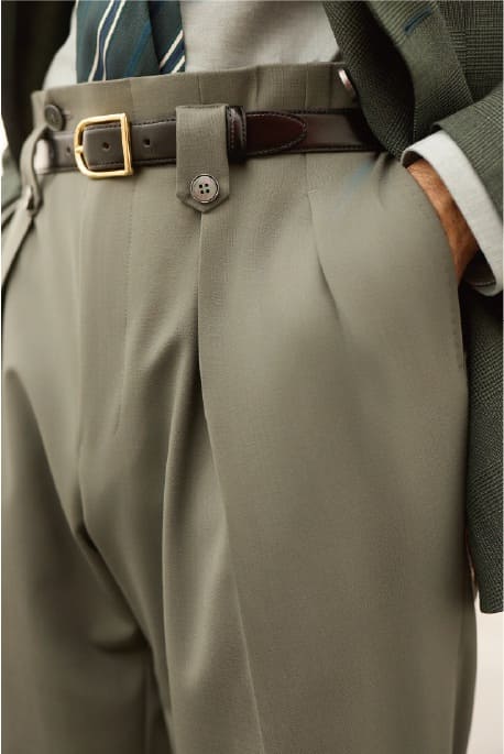 Men’s high-waisted pleated trousers with side adjuster and brown leather belt detail