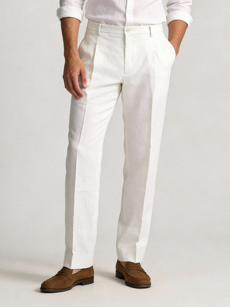 Men’s white tailored trousers with slim fit and brown loafers styling