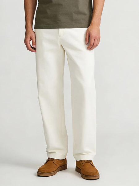 Men’s off-white trousers paired with olive green t-shirt and brown casual shoes