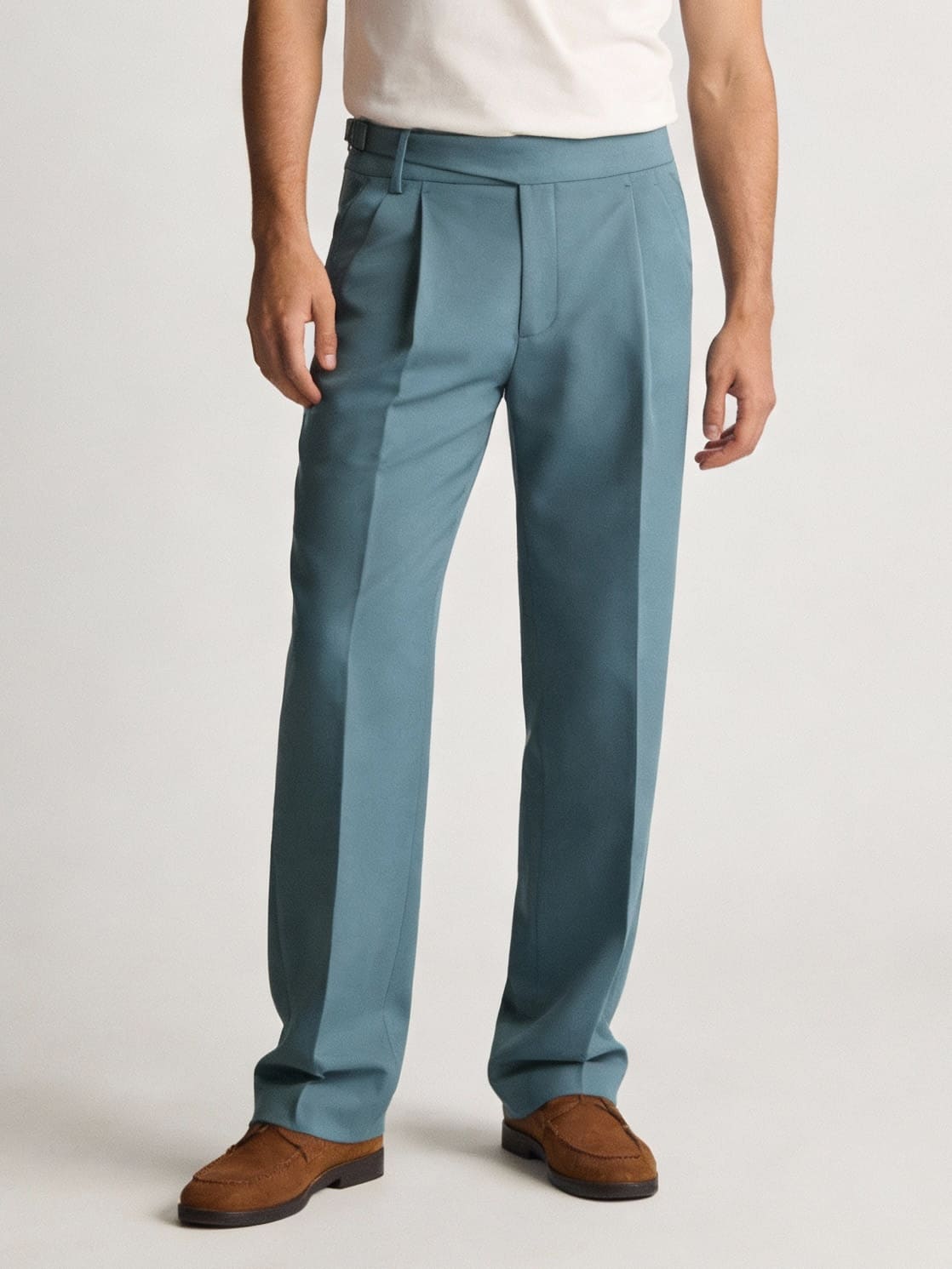 Men’s teal tailored trousers with pleats paired with brown loafers smart casual outfit